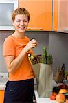 Girl just returned from supermarket with packet of vegetables