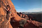 A female rock climber makes her way up a challenging route.