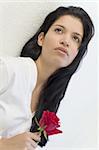 A beautiful young Hispanic woman holding a rose