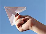 child hand with paper plane