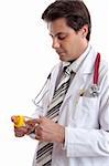Doctor or pharmacist reading  the label on a medicine bottle