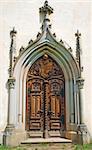 Medieval gothic portal with heraldry carving