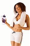 Dark skinned female in sporty outfit holding bottle of water