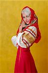 a beautifull woman in a folk russian dress on yellow background
