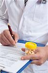 A medical healthcare  doctor with  health records and medicine.  Focus to hand with pills