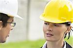 Young male and female managers working together in an industrial situation