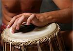 Man playing the djembe (nigerian drum) in studio