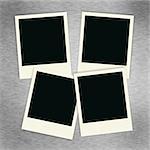 Four blank polaroid images on a brush aluminum background.