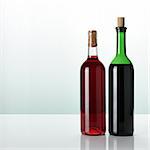 two bottles of wine on glossy surface