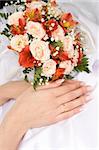 Bride's hands with french manicure and bridal bouquet