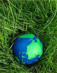 Green and Blue Globe with grass growing all around.