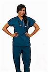 Full body of an attractive young brunette Hispanic woman health care worker standing with a smiling friendly expression on white