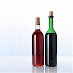 two bottles of wine on white surface