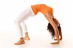 Dark skinned fit woman holding bridge stretching pose