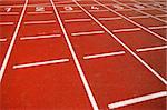 Numbers of a racetrack, on red tarmac, for runners