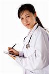 Female doctor with stethoscope in white background.