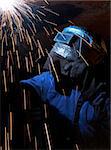 a welder working at shipyard at night