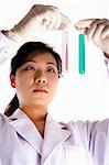 Female scientist with test tube in white background.