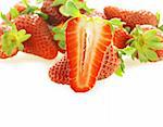 one cut fresh ripe strawberry and few as background with copy space. Focus on pulp