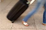 Woman and suitcase. Note that the picture is in motion blur.