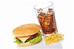 Cheeseburger, soda drink and french fries, reflected on white background. Shallow depth of field