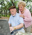 Senior couple on computer enjoying e-mail from their grandchildren.