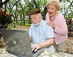 Senior couple on the internet reading a very funny e-mail.