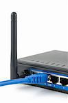 Blue network cable connected to a wireless router over white background