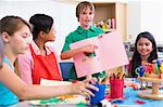 Elementary pupil discussing picture with classmates