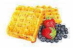Waffles, blueberries and strawberries isolated on white background