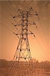 Power transmission pole against sunset skies