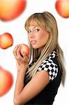 nice blond with a red apple in her hands and a checked black and white dress