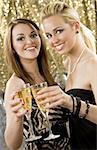 Two beautiful young women enjoying champagne in a nightclub