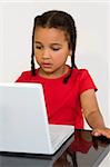 A beautiful young mixed race girl using a laptop computer
