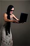 Portrait of young classy woman angry with her laptop