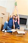 Young couple being silly with moving boxes at home
