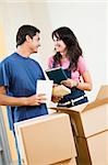 Young happy couple moving boxes at home