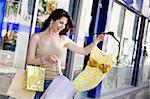 Mid adult Italian woman holding shopping bags