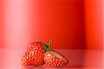 Close up view of nice fresh red berry on red back