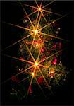 a christmas tree with electric candles on the black background