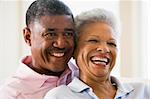 Couple relaxing in living room and smiling