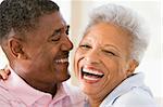 Couple relaxing indoors laughing