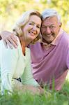 Couple relaxing in park smiling