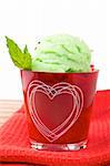 Delicious mint ice cream in red glass bowl. Shallow depth of field