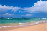 Peaceful beach scene with ocean and blue sky