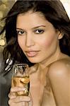 A beautiful young hispanic woman enjoying a champagne lifestyle