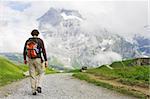 Young man hiking in Swiss Mountains, Switzerland, Jungfrau region