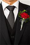red rose on suit jacket of groom