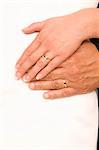 Bride and bridegroom hands over wedding dress (wedding rings)