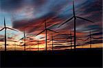 Wind power landscape at sunset on a flat horizon